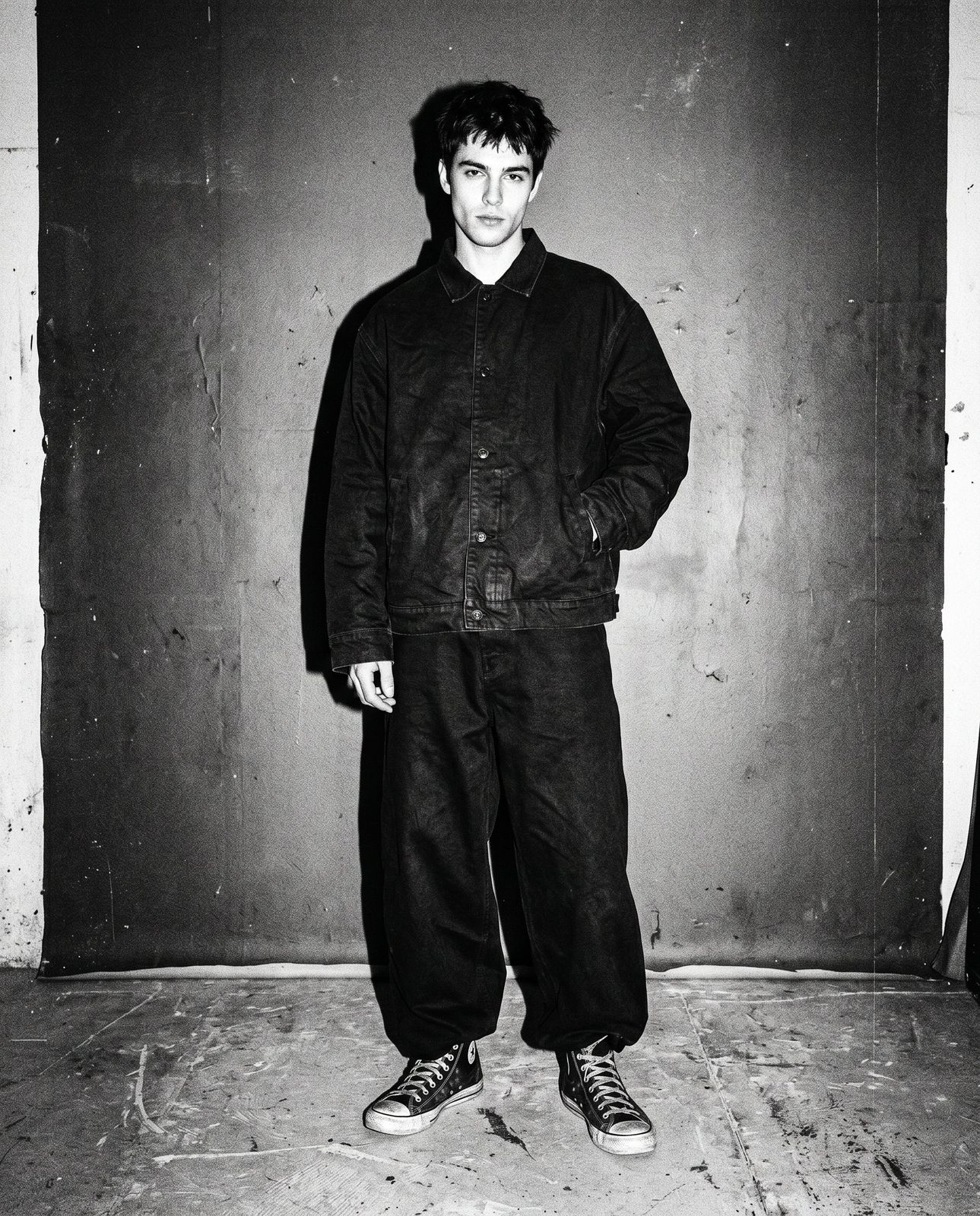 Model in oversized boxy jacket and wide pants, studio flash