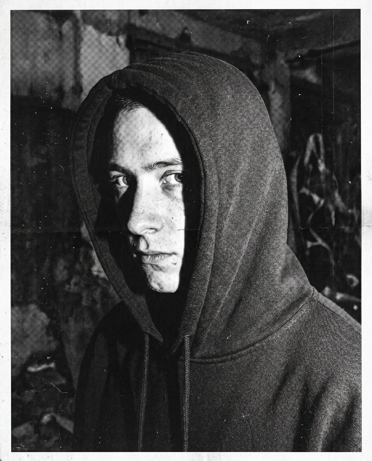 Close-up portrait, hood up, face half in shadow